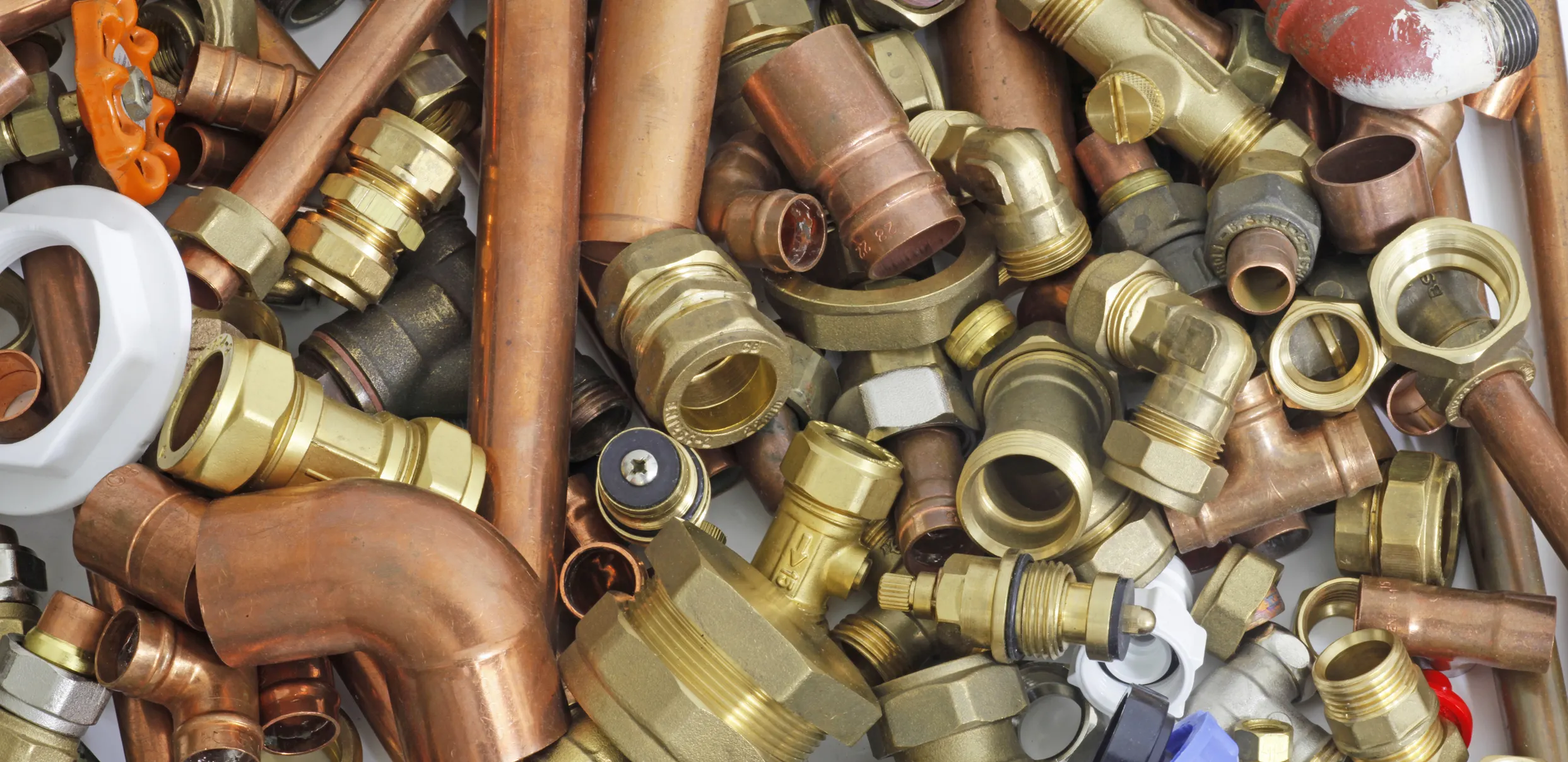 Random mixture of copper pipe and brass fittings