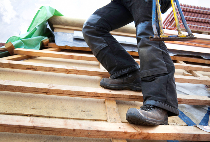 Man wearing ASTM F2413-18 safety footwear on demolition site