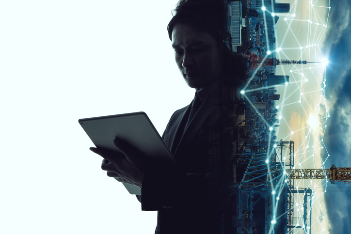 Man accessing the ISO/IEC TS 27008:2019 document for information security controls while connected city flourishes on the side.