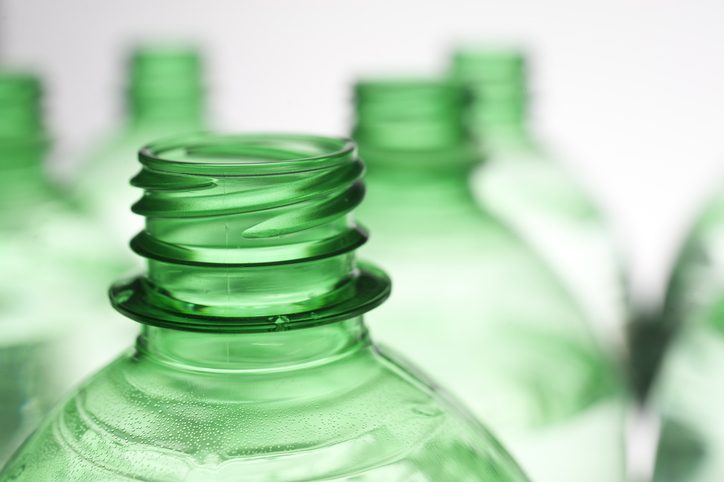Close up of green plastic bottle with Resin Identification Code (RIC) under ASTM D7611-18