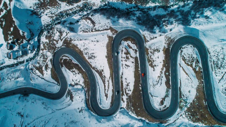 Car, or ISO 26262:2018 road vehicle, driving on windy snowy road