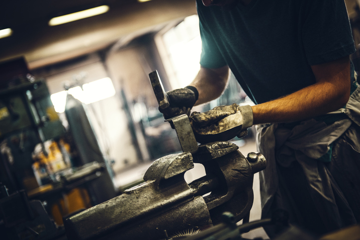 Striking a dirty hammer and wearing ANSI/ISEA 138-2019 impact-resistant gloves