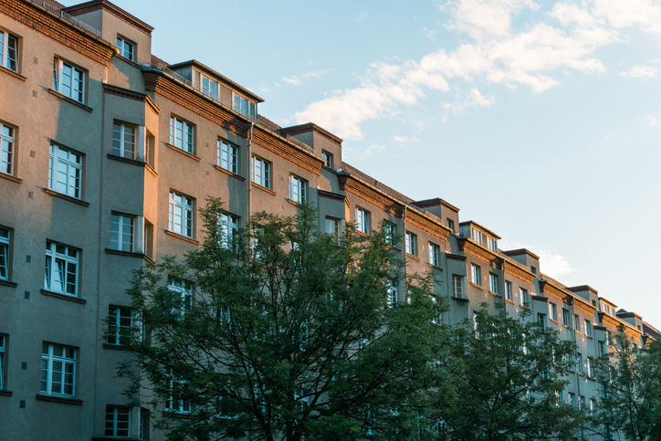 Low rise residential buildings under blue sky designed to ANSI/ASHRAE 90.2-2018.