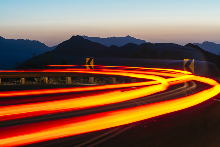 Nothing but bright lights arching at a turn due to the SAE J 578-2019 color specification for external lighting of motor vehicles.