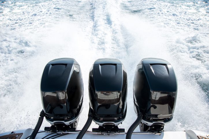 Outboard motors that meet ANSI AGMA 6032 requirements moving a boat through water
