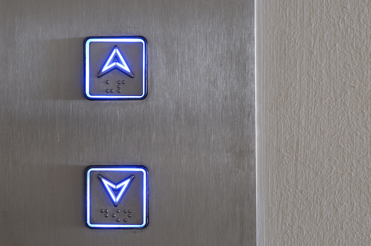 Up and down buttons of an elevator stay alight with ASME A15.5-2019 for electrical equipment.