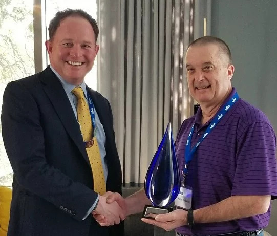 Keath Greenway gives Steve Holiday the first ANAB Assessor of the Year award.