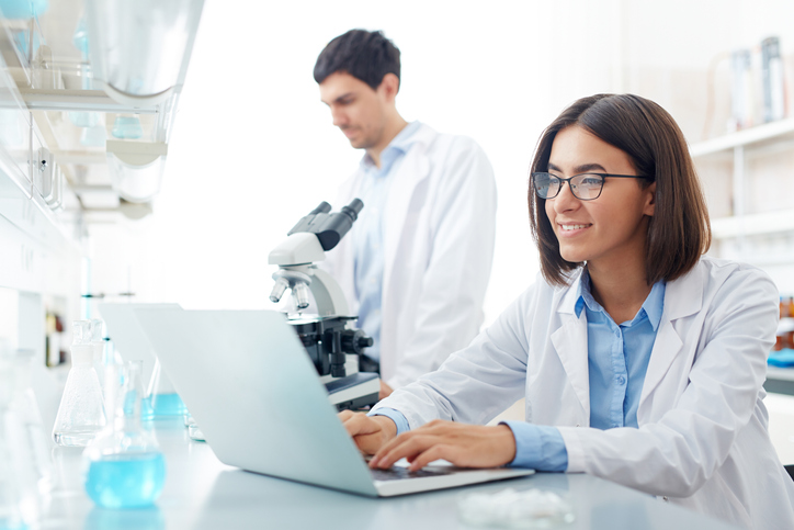 Female scientist researching tips for transitioning to ISO/IEC 17025:2017.
