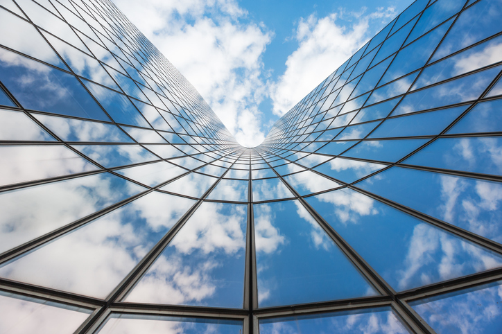 Bending building exterior beside sky following BACnet (Building Automation Control Network) under ANSI/ASHRAE 135.