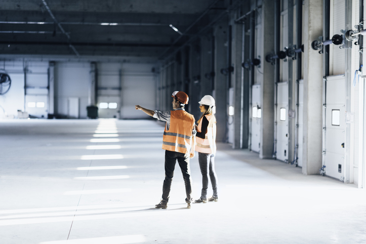 Safety professionals examining open facility in conducting ISO 41001 facility management.