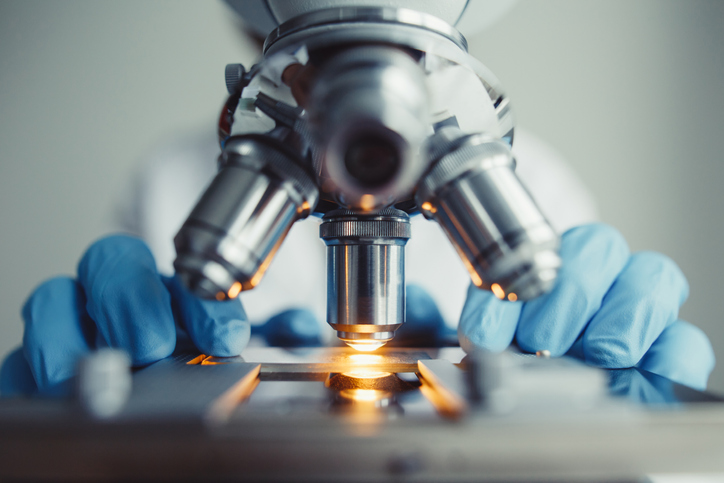 Closeup of microscope showing the impact the ISO/IEC 17025:2017 transition has had on labs and customers.