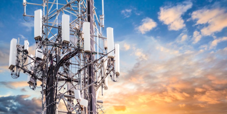 Telecommunications tower stays strong under the sunset thanks to ANAB accreditation for FCC testing laboratories.
