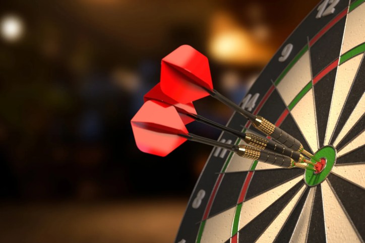 Three red darts find a bulls eye to depict accuracy and precision in ISO 5725-2:2025 that is repeatable.