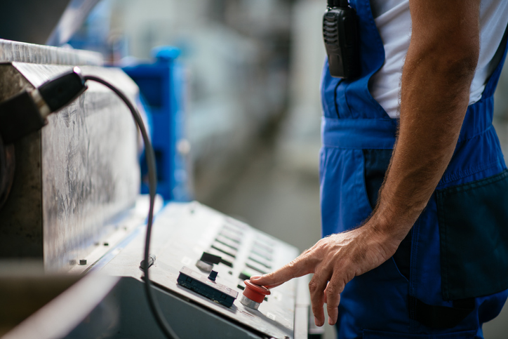 Caution warning on a piece of machinery that follows guidelines set by ANSI B11.19-2019