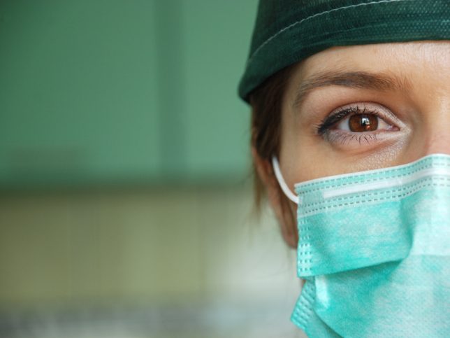 Woman wearing a medical face mask designed to ASTM F2100-20.