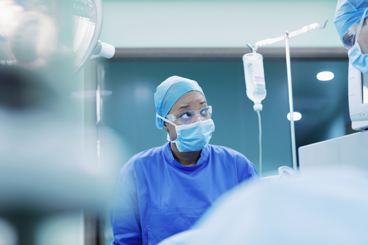 Woman in an operating room with personal protective equipment on that is specified in ANSI/AAMI PB70:2012