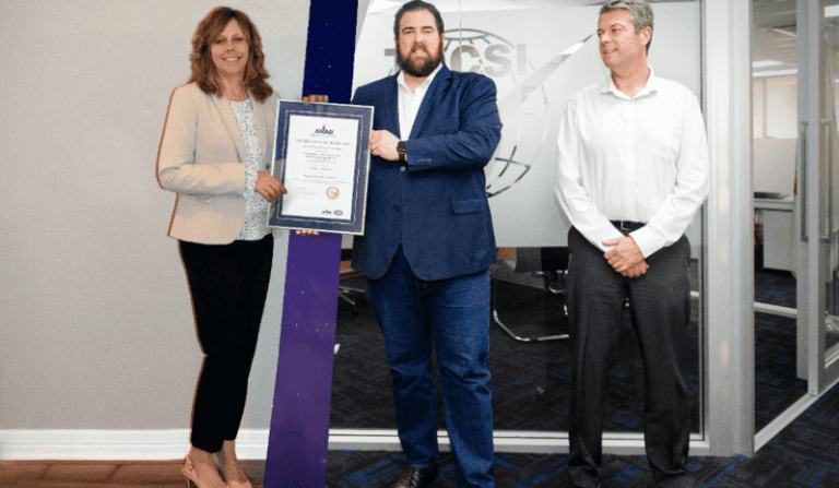 ANAB handing the first remote accreditation certificate to TQCS International via remote assessment to AS9100 and AS9120.