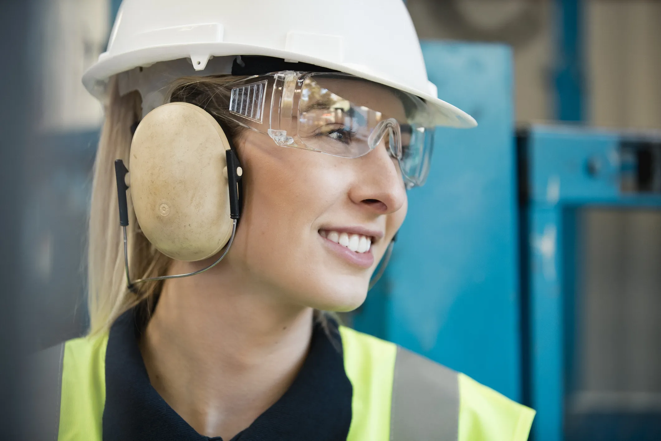 Happy woman wearing ANSI/ISEA Z87.1-2020 safety glasses to protect her face