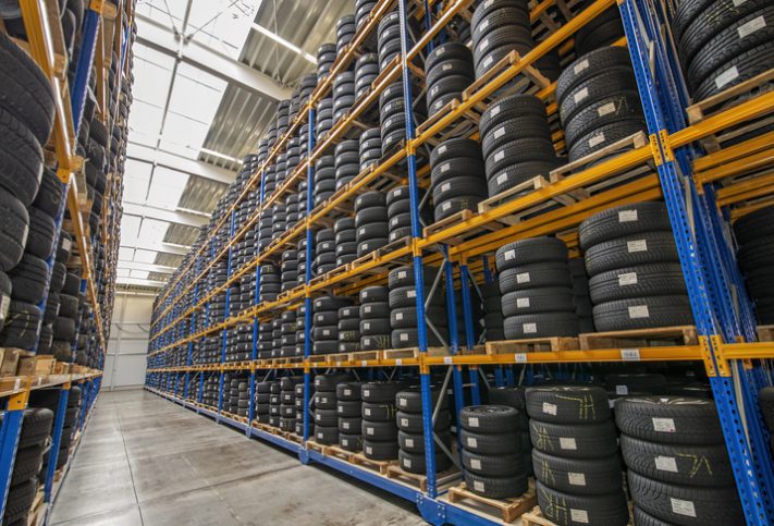 Stacked tires on yellow shelves tested to SAE J 175-2020