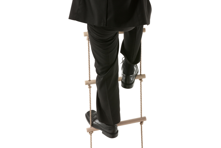 Climbing an ANSI E1.1-2018 wire rope ladder on white background while acting in play.