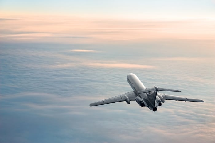 A sunrise plane journey moves smoothly above the clouds thanks to AS 9100 Series Standards.
