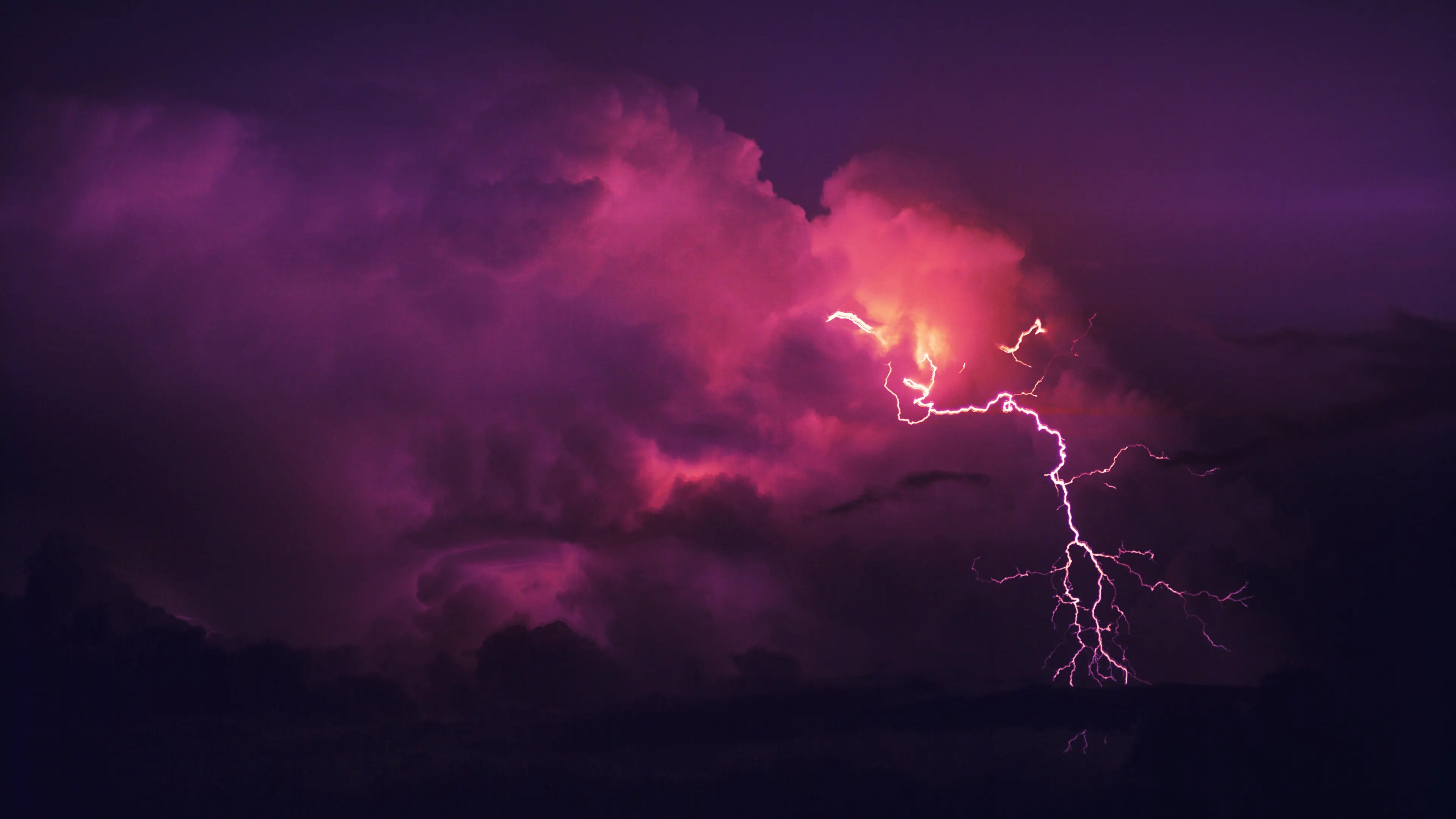 Red thunderstorm crashing in the clouds to represent overvoltages from not rating to ANSI C84.1-2020.