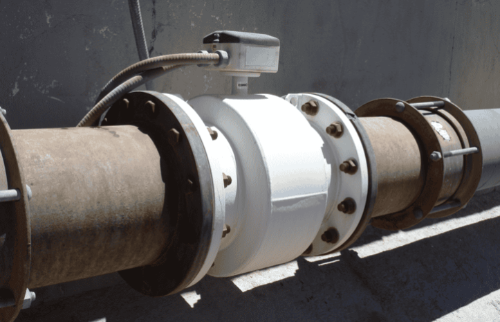 A rusty magnetic inductive flowmeter (magmeter) installed in accordance with AWWA C751-2019.