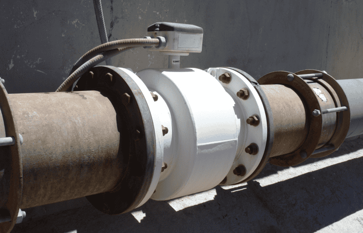 A rusty magnetic inductive flowmeter (magmeter) installed in accordance with AWWA C751-2019.