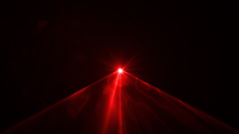Red laser emitting through amplified darkness in ANSI Z136.1-2022 safe use.