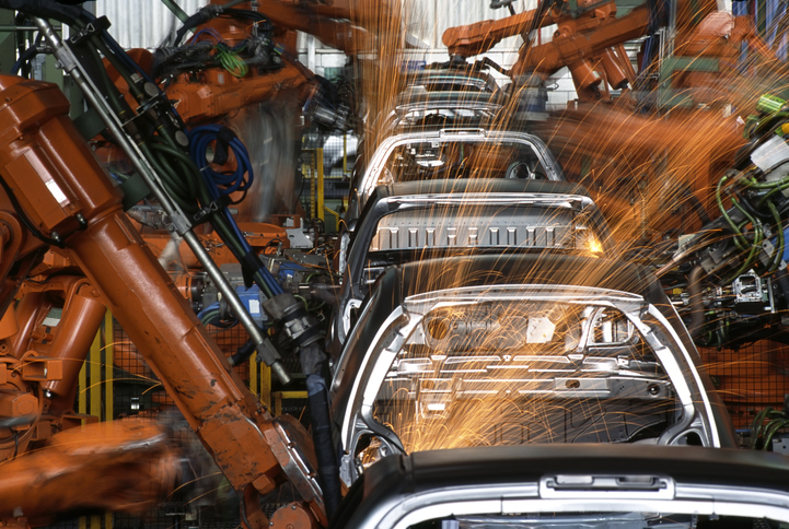 Robot arms manufacturing automobiles in compliance with IATF 16949 and ANAB accredited laboratories.