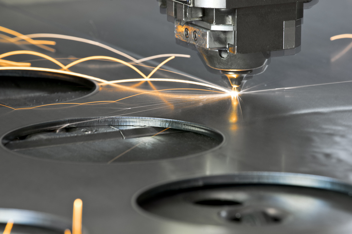 CNC machining slicing through metal with a laser with standard tooling parts.