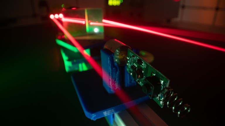 Red lasers amplifying through ANSI Z136.8-2021 approved research, testing, and development for safe use.