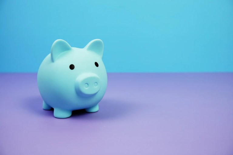 Blue piggy bank purple ground for financial planning of ASTM E2659 accredited certificate issuer programs.