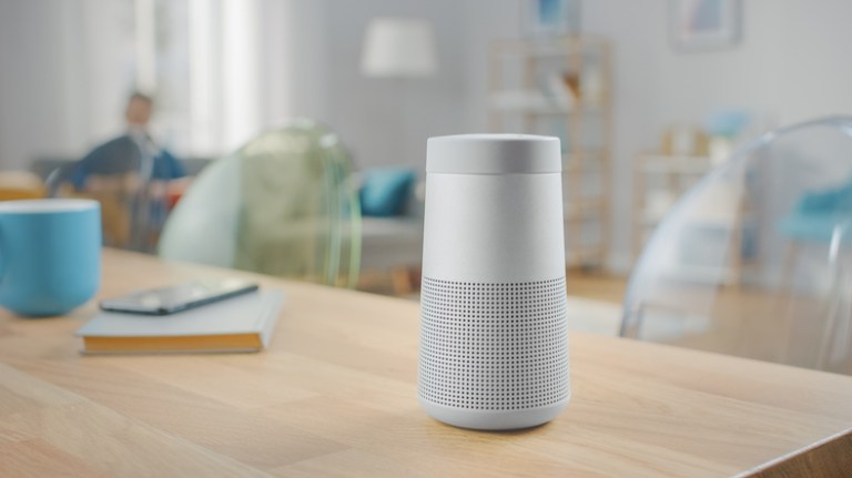 Silver wireless bluetooth speaker sitting on table after unlicensed wireless device testing to IEEE/ANSI C63.10-2020.