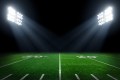 Verdant football field at night with stadium lights set properly with ANSI/IES RP-5-21 illumination.
