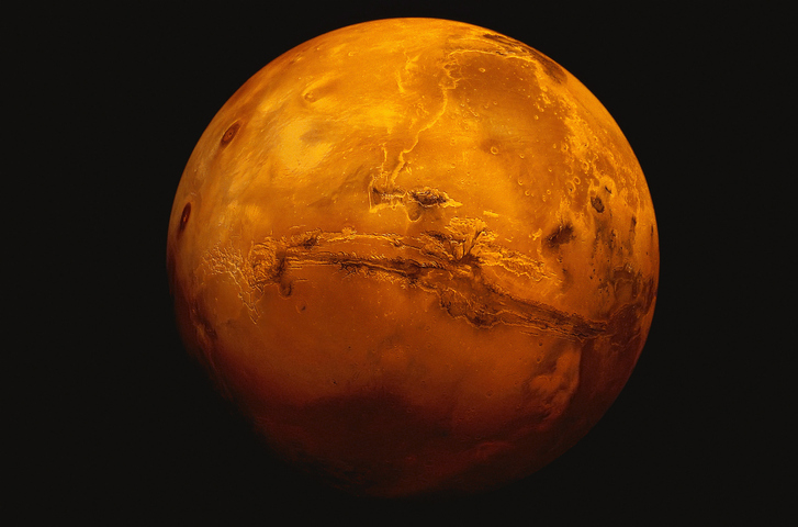 Mars red planet with surrounding black space, on which 3D printing will one day thrive.