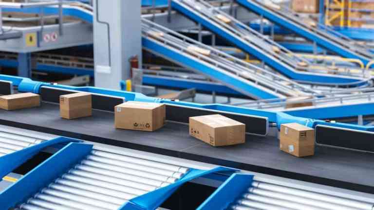 Blue conveyor shuttling boxes and kept safe thanks to ASME B20.1-2024.
