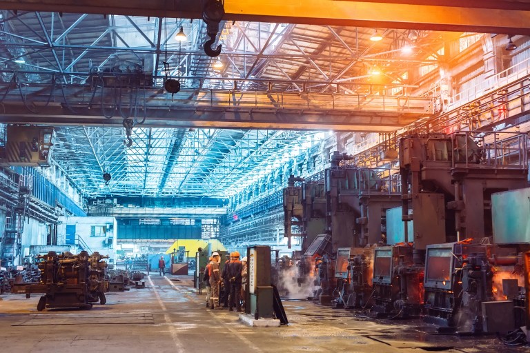 Workers in a steel plant that are kept safe due to ANSI/ASSP Z590.3-2021 prevention through design guidelines.