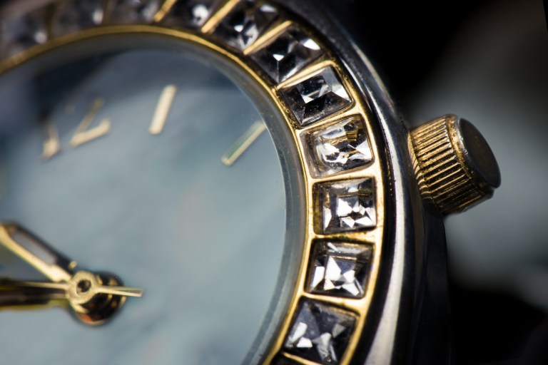 A gold rolex with IEC 60086-3:2021 watch batteries properly fitting inside under standard conditions.