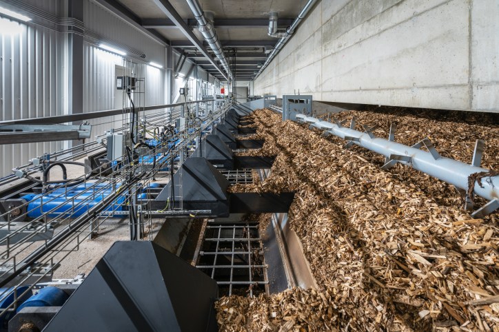 Wood chips being ground for biomass in factory in accordance with Sustainable Biomass Program SNP requirements.