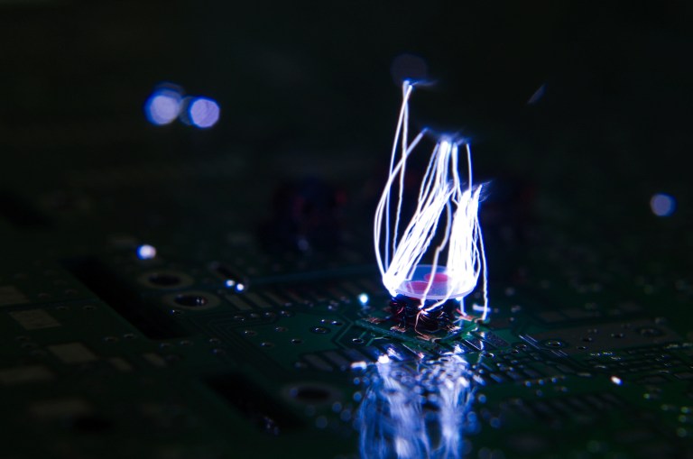 Electrostatic discharge (ESD) destroying PCB in the dark in need of ANSI/ESD S20.20-2021 electronic protection.