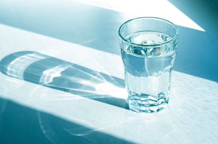 Shadow casting over glass of water resulting from NSF/ANSI standards from the treatment of their components.