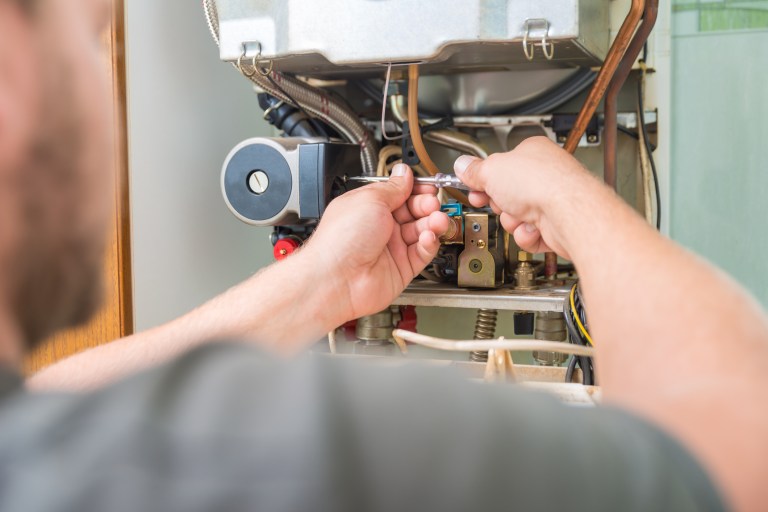 Someone testing annual fuel utilization efficiency (AFUE) of a residential boiler by following ANSI/ASHRAE 103-2022.