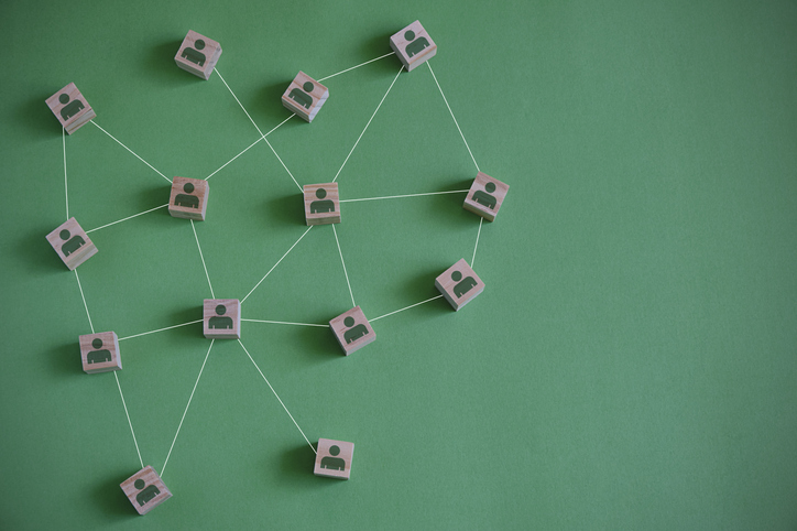 Cubes of certification bodies on green background sharing data.
