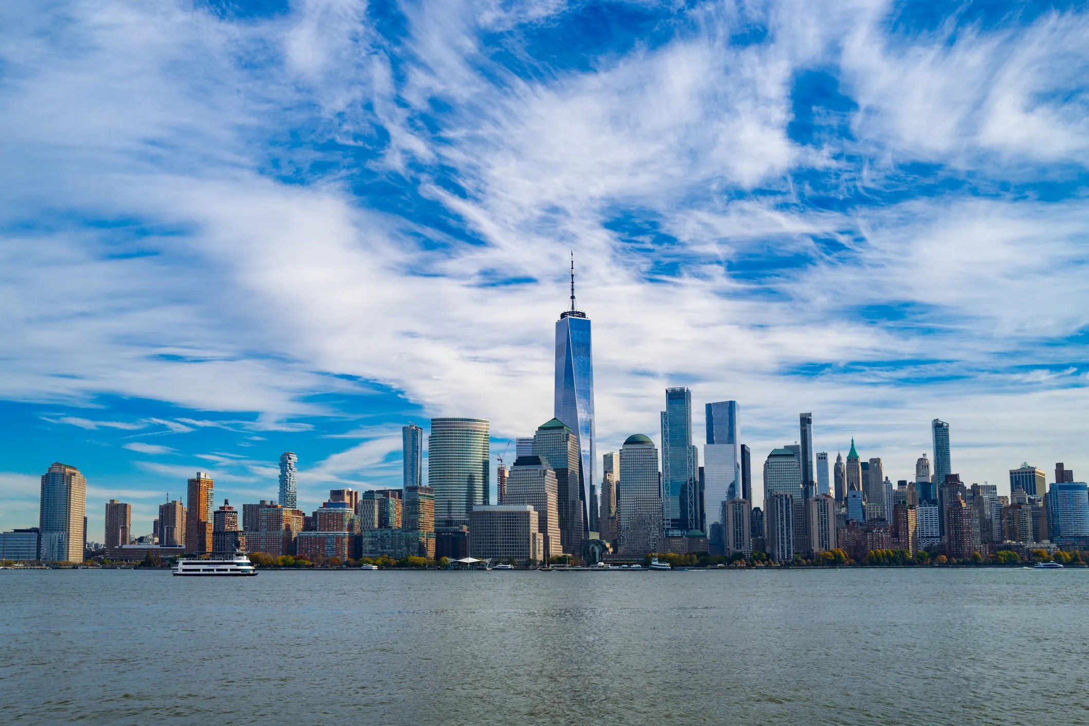 New York City skyline beneath blue sky and clouds, filled with wind tunnels