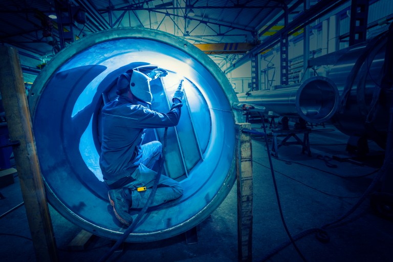 Welding in blue confined space of a pipeline safely with ANSI/ASSP Z117.1-2022 performance requirements.