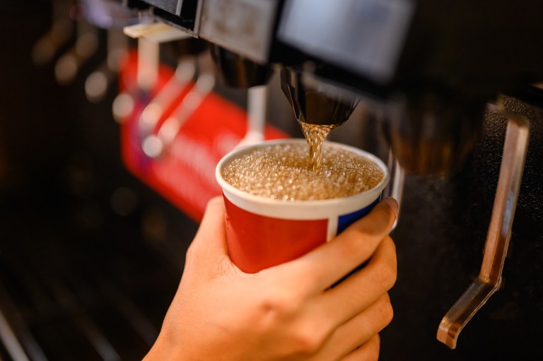 Soda fountain dispensing cola beverage with the help of ASSE Standard 1022-2021 backflow preventers.
