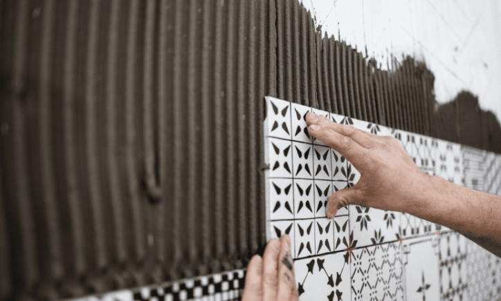 Some ceramic tile being installed by hand to ANSI A137.1:2022 specifications.