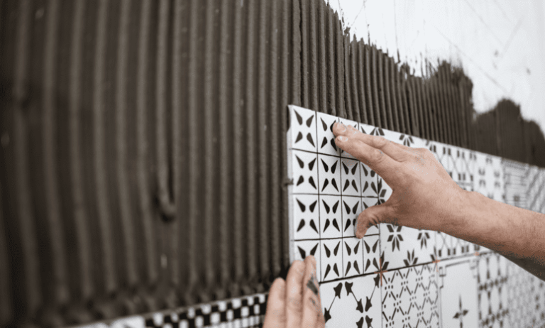 Some ceramic tile being installed by hand to ANSI A137.1:2022 specifications.