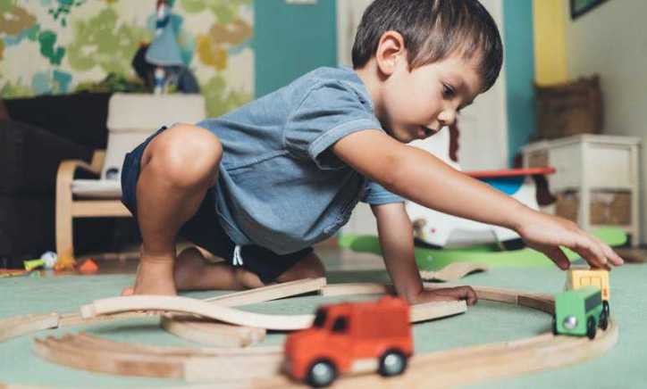 Boy playing with toy cars tested to CPSC and ISO 17025 lab requirements accredited by ANAB.